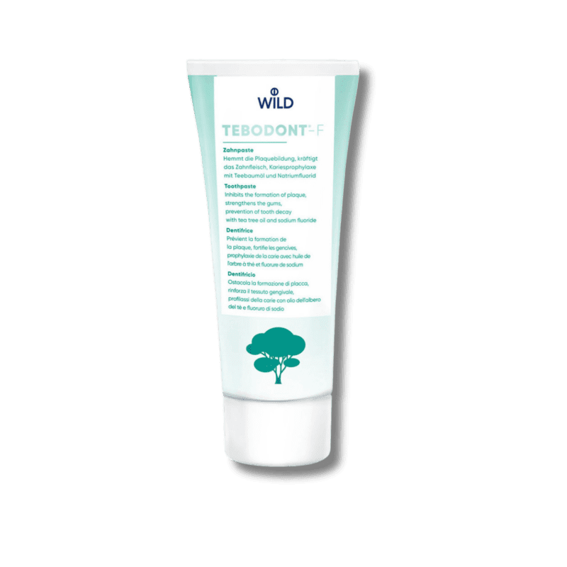 Un tube de dentifrice Wild Pharma Tebodont-F au fluor 75 ml, avec un arbre dessus.