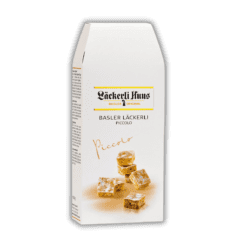 Swiss Made Direct Shop 40 A box of white chocolate Basler Leackerli Piccolo 150 g with a white label on it.