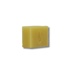 An individual Orange Spice Soap bar with a tiny hole, showcased against a dark background.