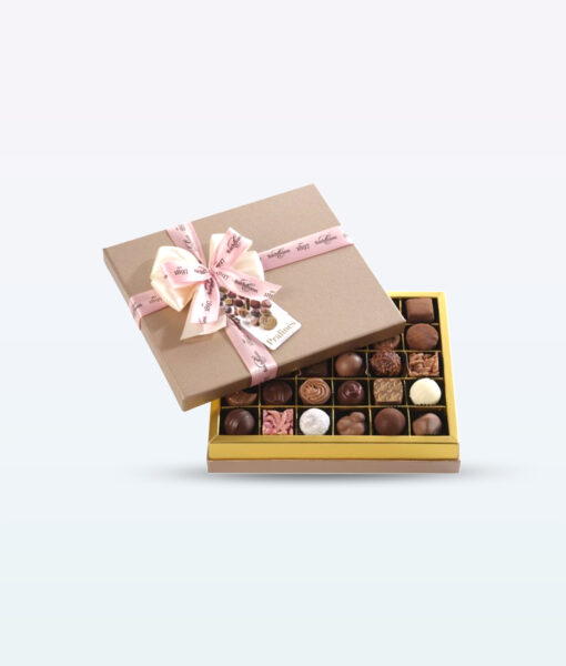Pink-ribboned brown box holding a mix of Bachmann pralines.