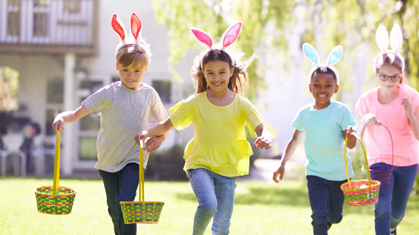 group of children wearing bunny ears running to YBA3K2H