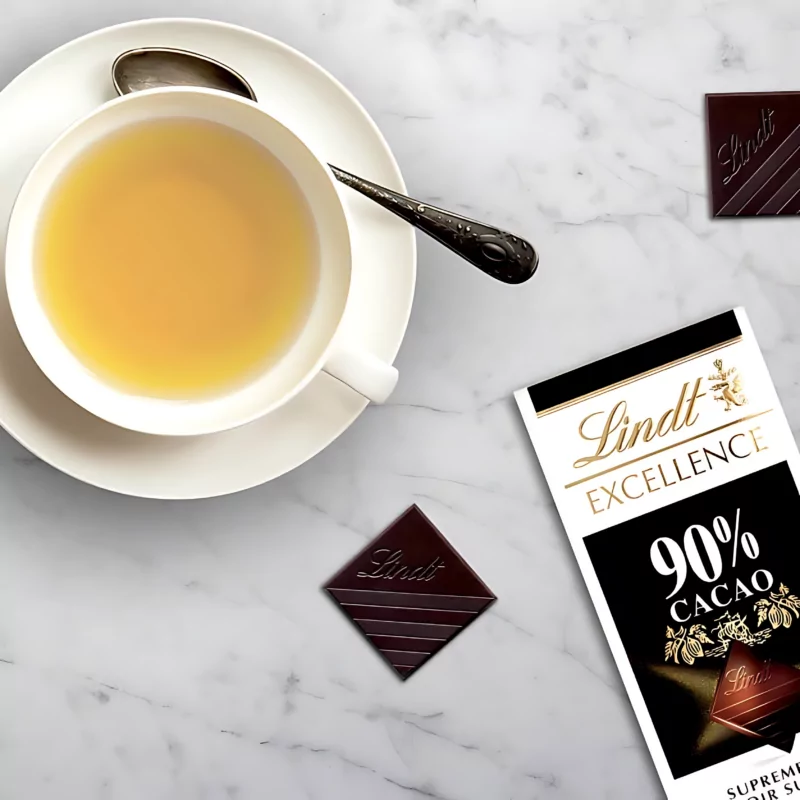 Experience the pinnacle of Swiss chocolate excellence at Swissmade.direct. Delight in the refined luxury of a Lindt Excellence 90% cacao chocolate bar, elegantly showcased alongside an exquisite tea cup. Savor the unparalleled richness and sophistication of Swiss chocolate brands, available exclusively at Swissmade.direct.