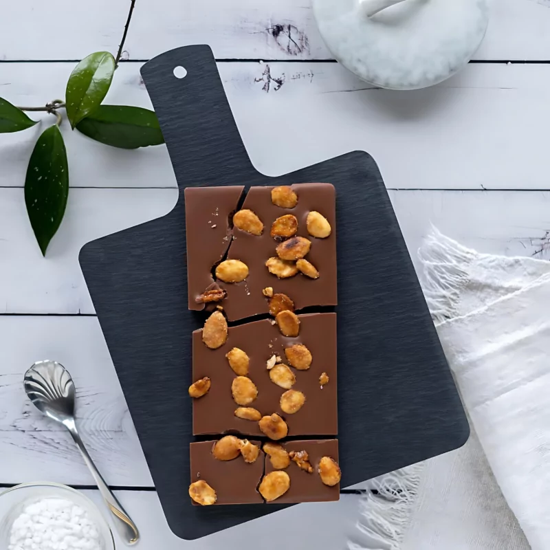 Enjoy the rich flavor of Swiss chocolate topped with crunchy nuts, showcasing the exquisite craftsmanship of one of the top Swiss chocolate brands. Dive into a sensory delight with this delectable treat from the world-renowned Swiss chocolate industry.