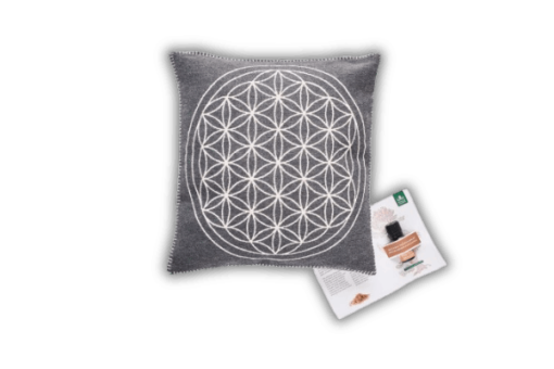 A cushion with a flower of life design on it.