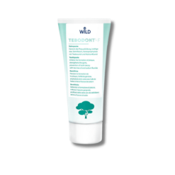 A tube of Wild Pharma Tebodont-F toothpaste with fluoride 75 ml, with a tree on it.