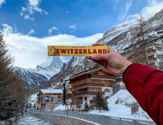 A Swiss local presenting a delicious chocolate bar.
