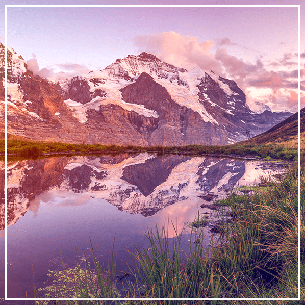 A mountain range is reflected in a lake.