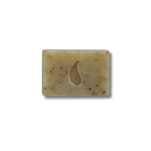 A lavender Seifenmacher soap bar with specks and a half-burned wick on a black backdrop.